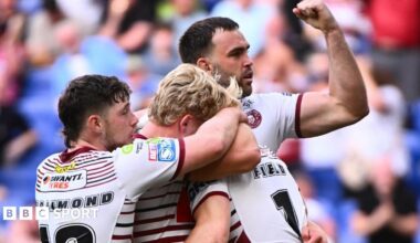 Jai Field is engulfed by Wigan Warriors team-mates after scoring against St Helens