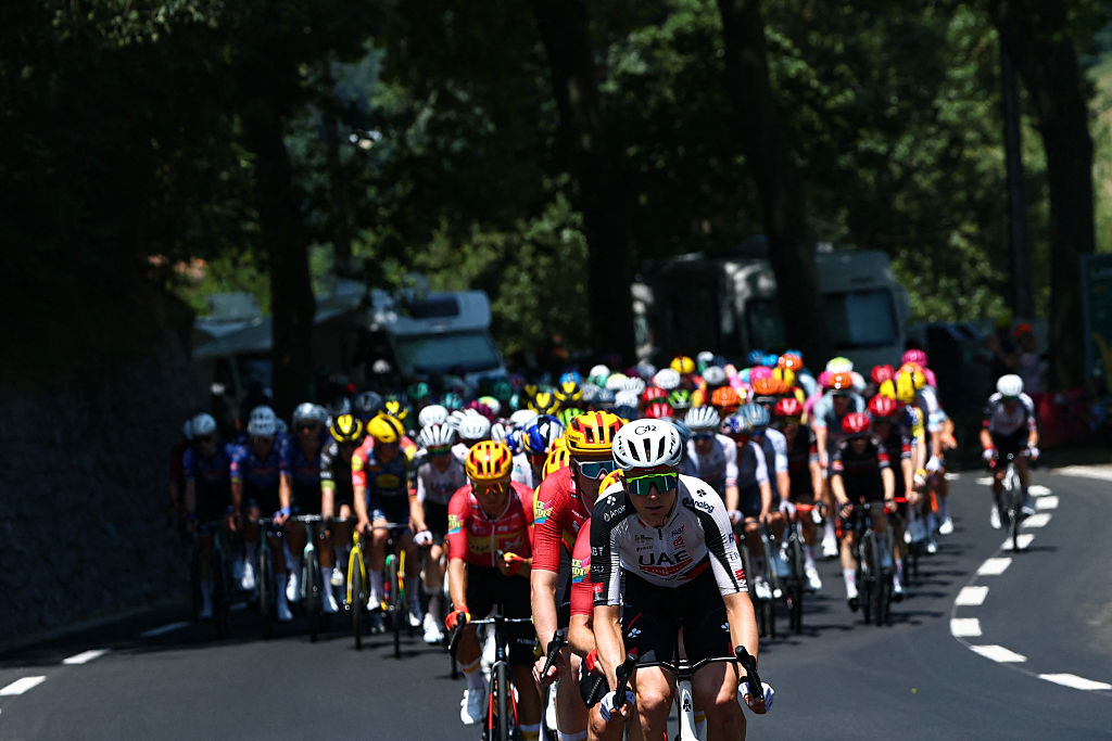 The pack of riders (peloton) cycles in the Col d'Aspin ascent during the 6th stage of the 113th edition of the Tour de France cycling race, 186,2 km between Pau and Gavarnie-G&egrave;dre in the French Pyrenees, on July 9, 2026. (Photo by Anne-Christine POUJOULAT / AFP)