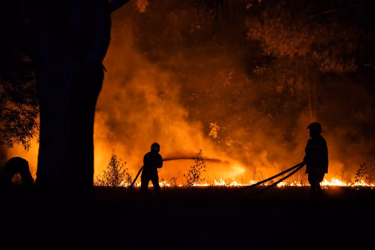 Firefighters attempt to control the wildfire near Lege-Cap-Ferret, southwestern France