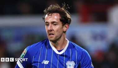 Ryan Wintle in a blue Cardiff City jersey.