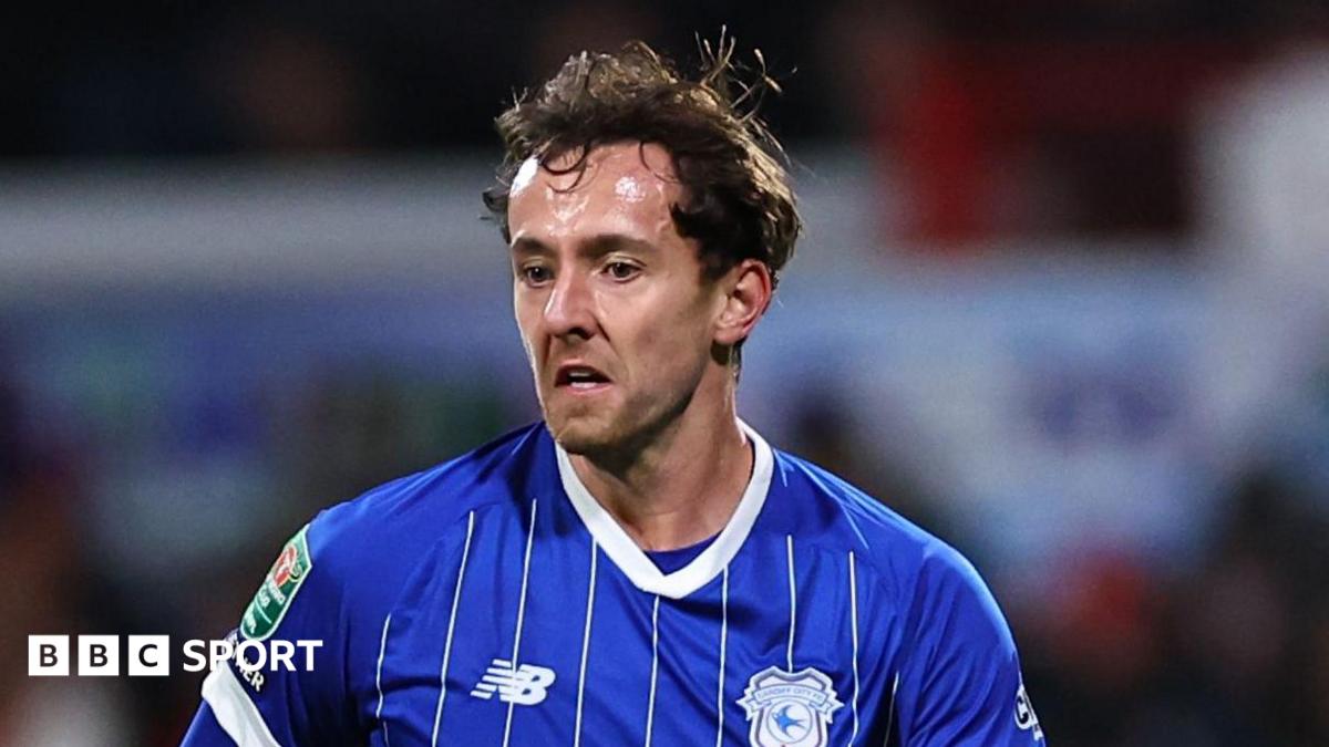 Ryan Wintle in a blue Cardiff City jersey.