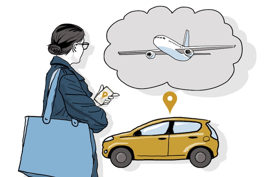 Woman, hair tied low, glasses, in dark blue coat, light blue large bag, holding a phone with a car and plane in the background.