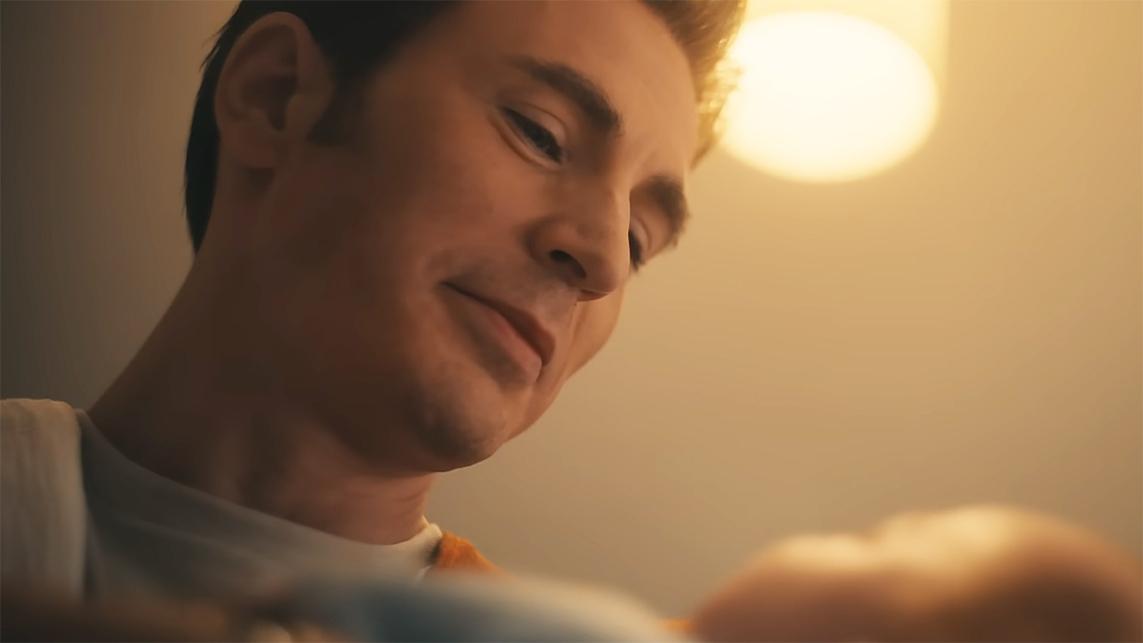 Steve Rogers smiling as he looks down as his newborn son in Avengers: Doomsday