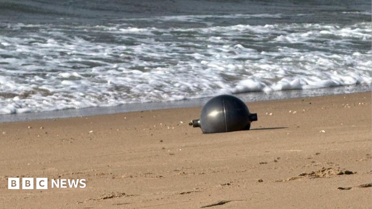 One of the six mysterious large silver spheres washed up on Forrest Beach in Queensland.