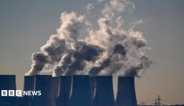 Cooling towers release water vapor at the Jaenschwalde lignite-fired power station in Jaenschwalde, Germany