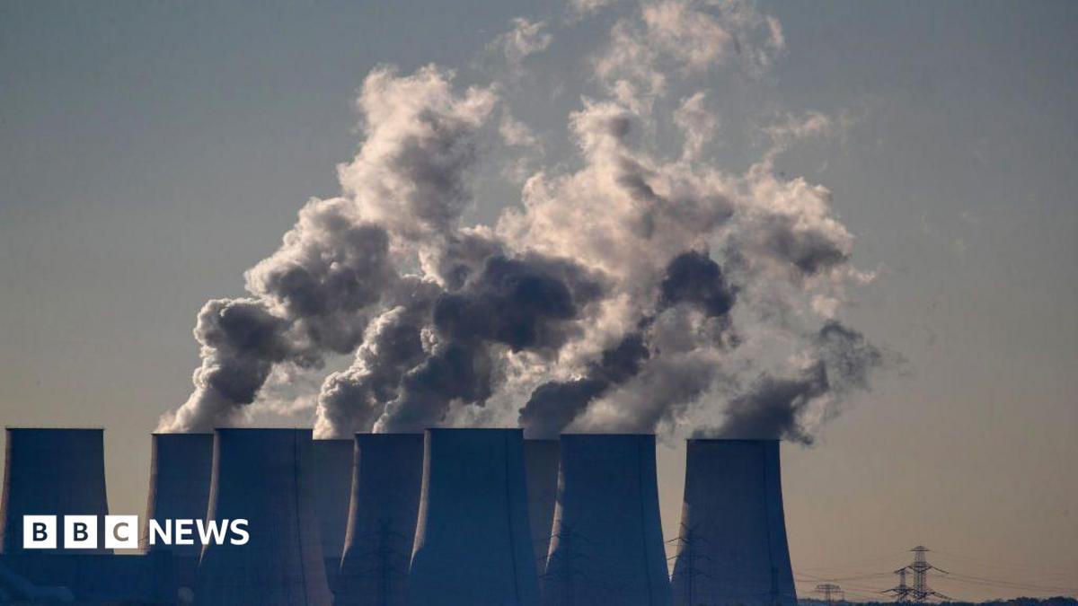 Cooling towers release water vapor at the Jaenschwalde lignite-fired power station in Jaenschwalde, Germany