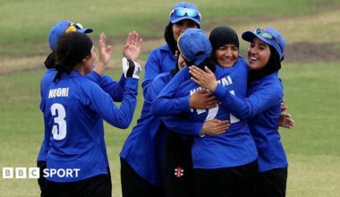 Afghanistan's women celebrate a wicket during a T20 match against Cricket Without Borders XI at Junction Oval in Melbourne in 2025
