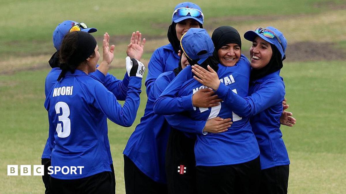 Afghanistan's women celebrate a wicket during a T20 match against Cricket Without Borders XI at Junction Oval in Melbourne in 2025