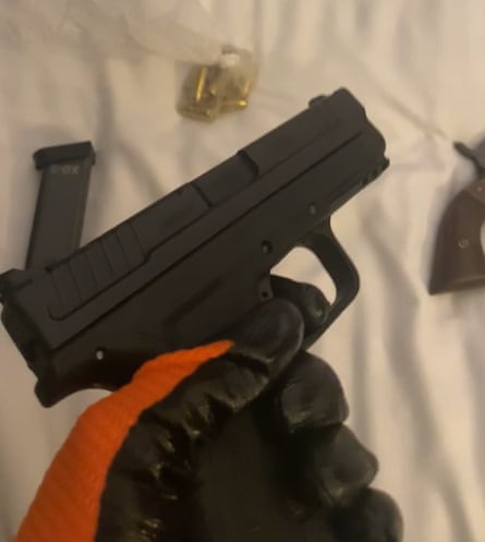 Photo issued by the Metropolitan police of Johannes Natland wearing gloves while handling a gun. Natland not visible