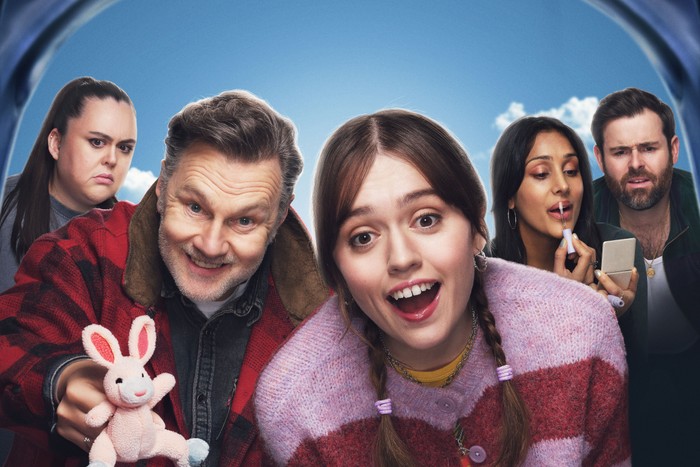 530786 Sharon Rooney as Catherine, David Morrissey as Malcolm, Aimee Lou Wood as Gemma, Taj Atwal as Cherry and David Fynn as Derek in Daddy Issues. The image is from the perspective of a baby in a cot, with the others all gathered around, looking in.