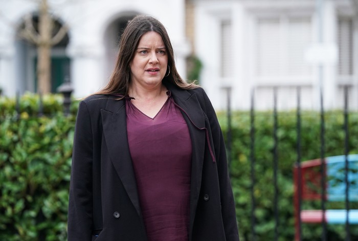 Michelle Ryan as Zoe Slater standing in the street in EastEnders.