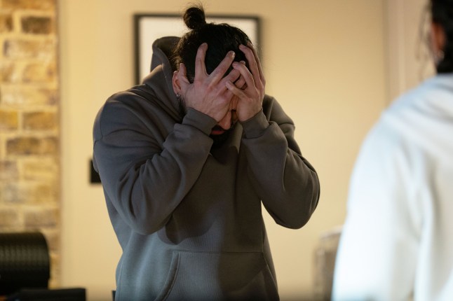 Ravi Gulati with his head in his hands in EastEnders