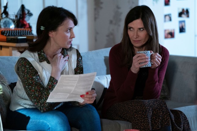 Bea Pollard staring at Honey Mitchell as they talk on the sofa in EastEnders.