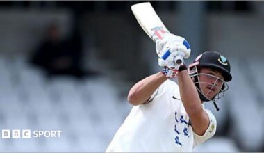 Sussex batter Tom Clark in all white with bat in backlift after a shot