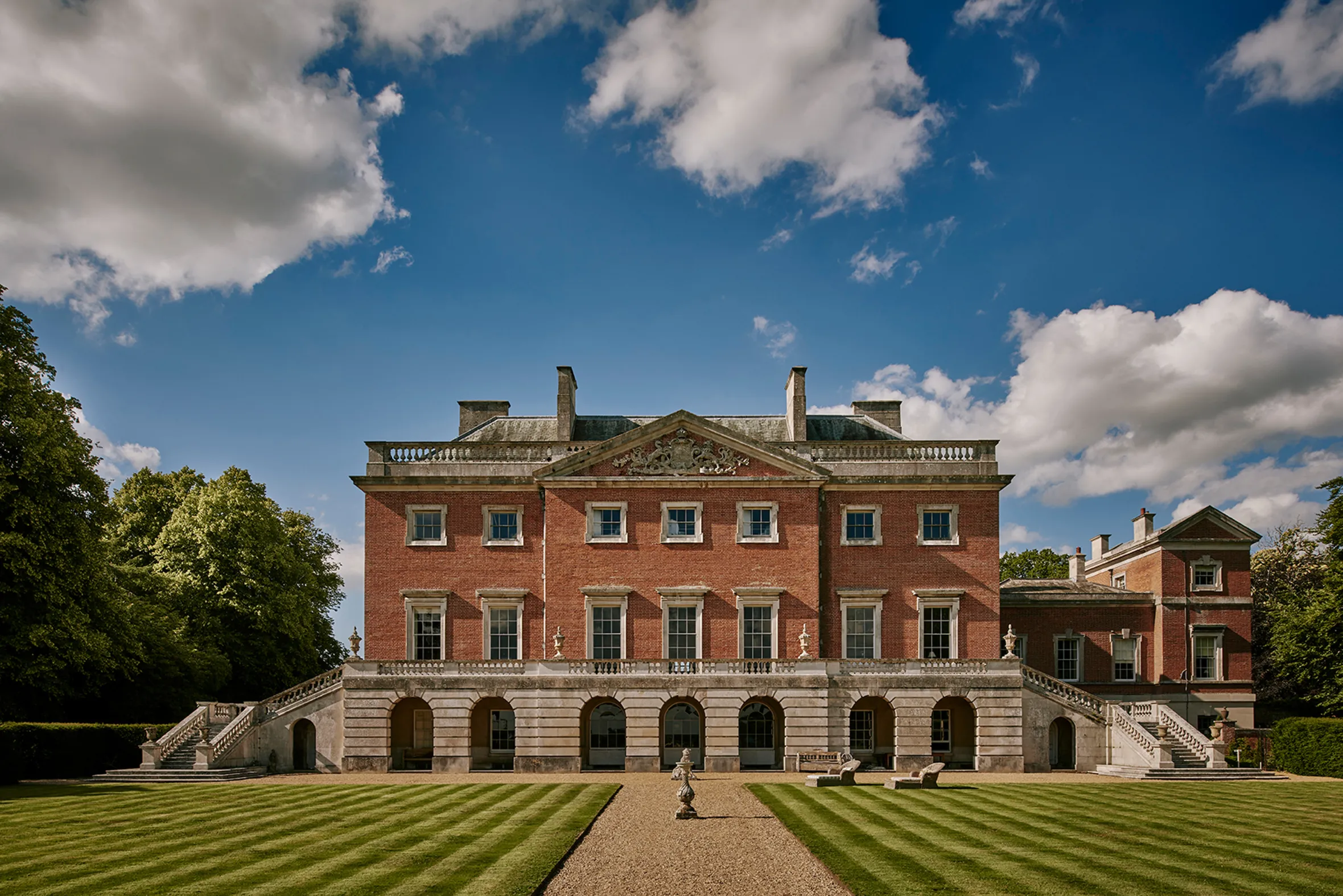 Wolterton Hall in Norfolk, a red brick country house with a grand entrance and manicured lawn.