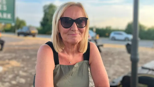 Debbie Thaxter wearing sunglasses outside