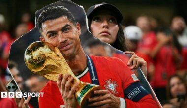A Portugal fan holds a cardboard cutout of Cristiano Ronaldo with the World Cup trophy during the World Cup