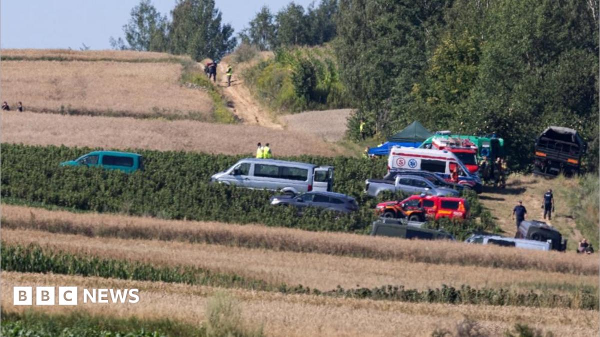 Emergency services work at the site where an unidentified flying object, believed to be a Russian cruise missile, as Ukraine's foreign minister said on Thursday, fell after violating Polish airspace