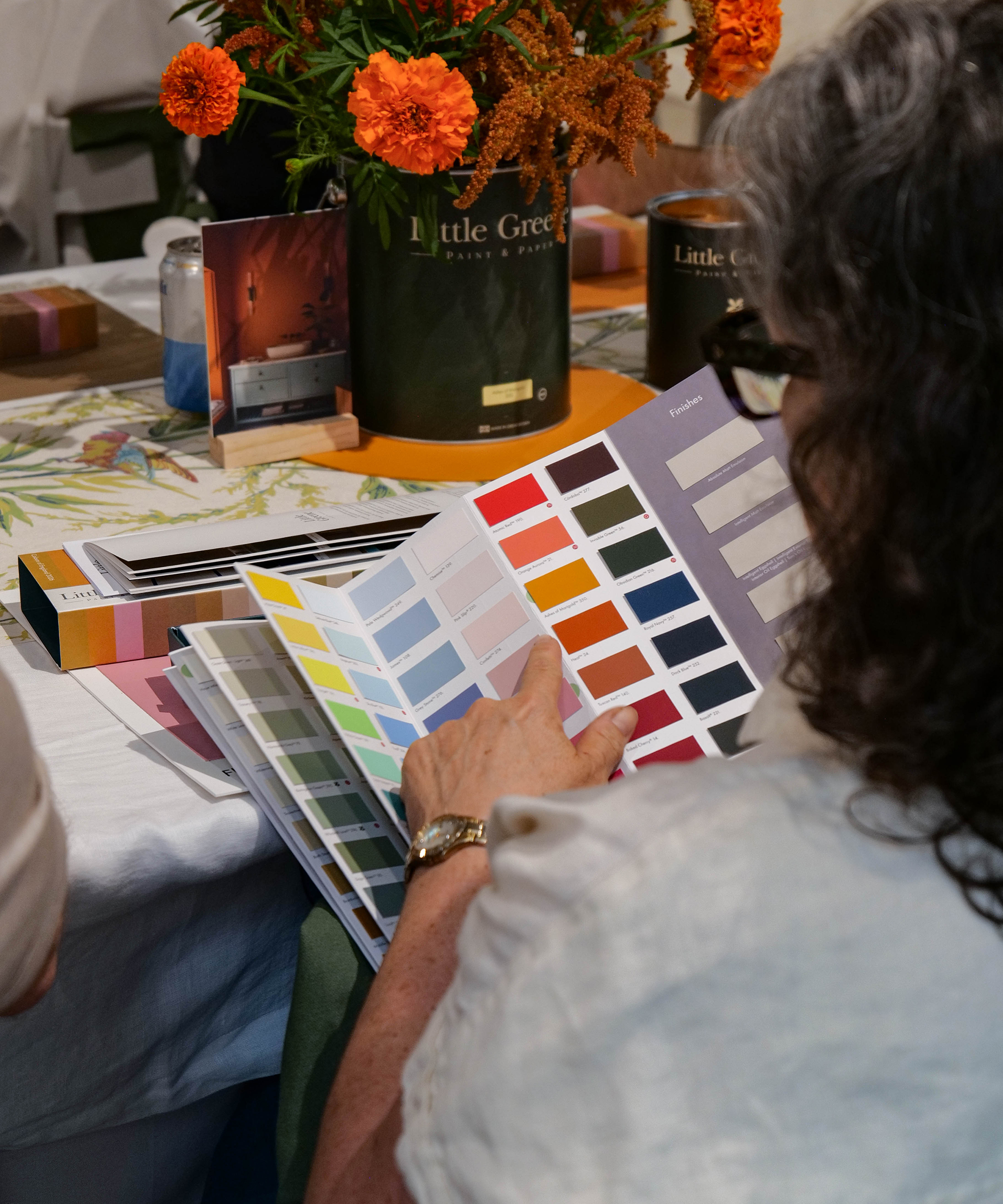 a woman looking at paint chart