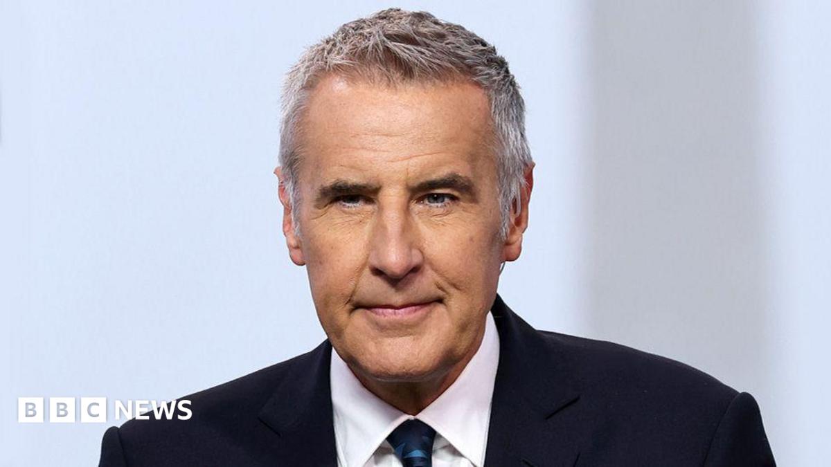 Dermot Murnaghan, with short dark grey hair, in a suit looking slightly off camera