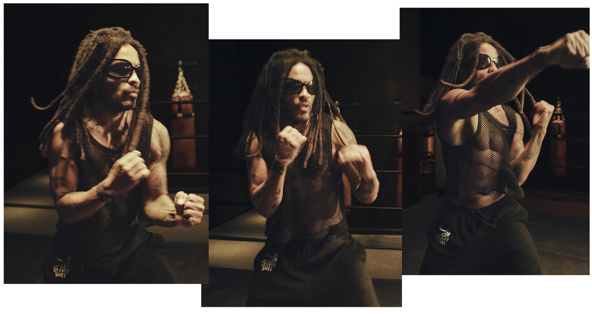 A muscular person with dreadlocks wearing sunglasses performs a boxing stance in a training space.