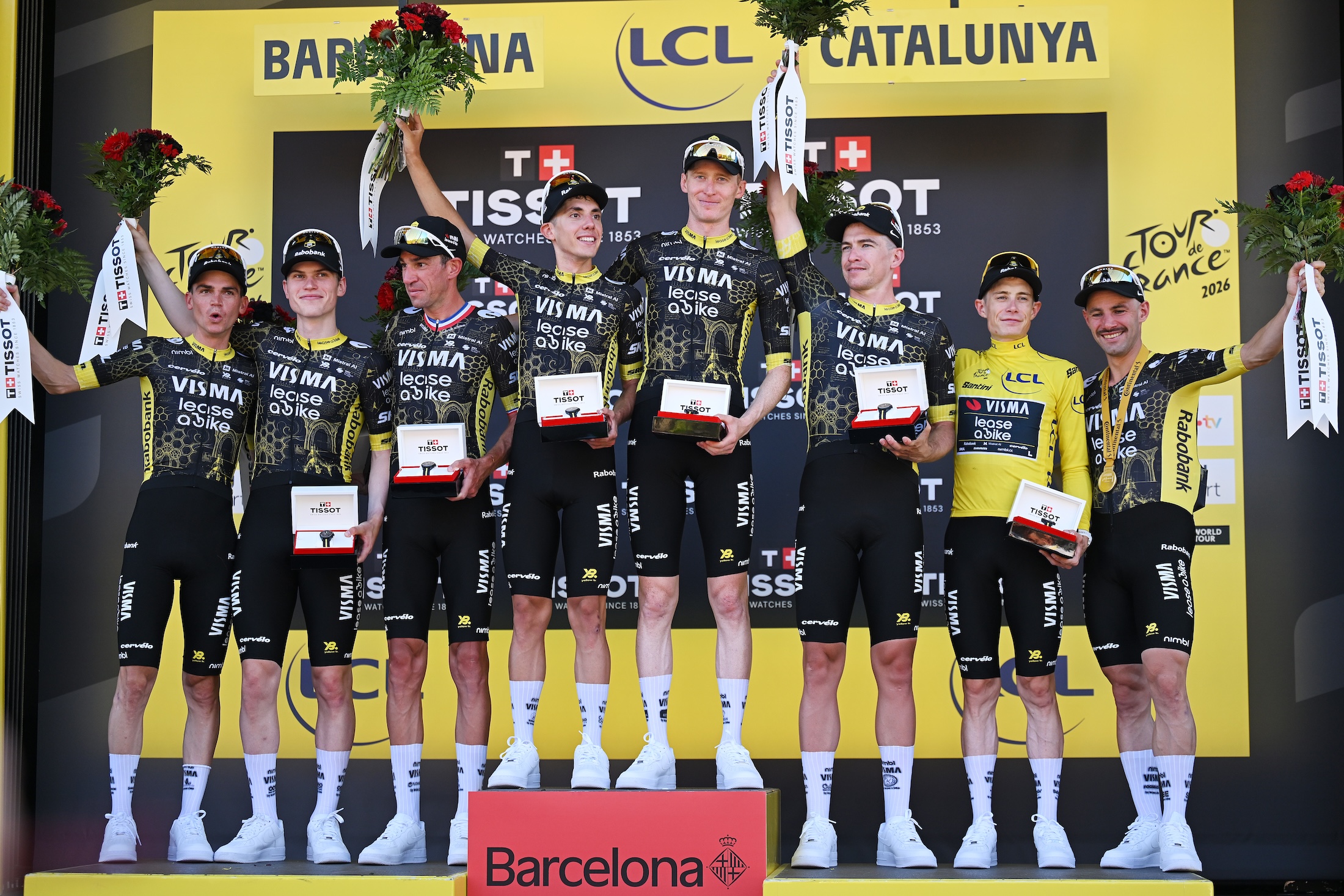 BARCELONA, SPAIN - JULY 04: Jonas Vingegaard of Denmark, Edoardo Affini of Italy, Bruno Armirail of France, Victor Campenaerts of Belgium, Per Strand Hagenes of Norway, Matteo Jorgenson of United States, Sepp Kuss of United States, Davide Piganzoli of Italy and Team Visma | Lease a Bike celebrate at podium as stage winners during the 113th Tour de France 2026, Stage 1 a 19.6km team time trial stage from Barcelona to Barcelona / #UCIWT / on July 04, 2026 in Barcelona, Spain. (Photo by Tim de Waele/Getty Images)