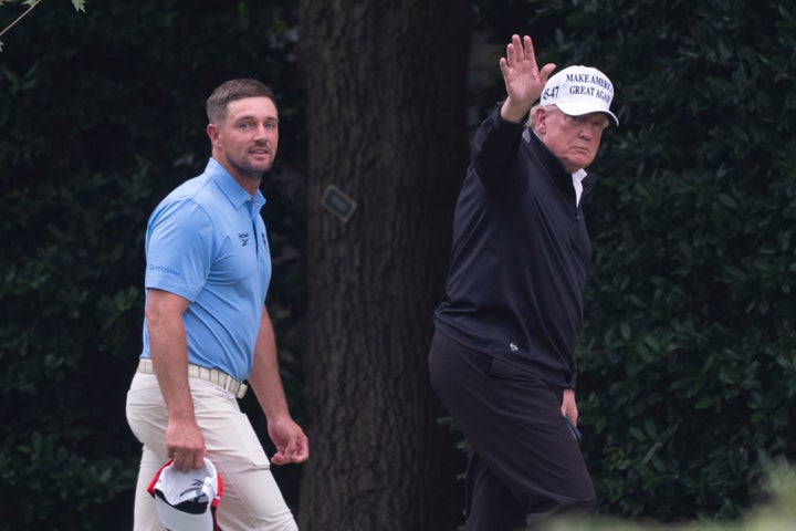 President Donald Trump (right) walks toward the Oval Office with 2024 U.S. Open winner Bryson DeChambeau after playing golf last year. 