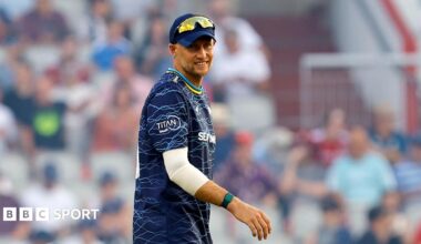Joe Root in a blue Yorkshire top and cap with sunglasses on his head facing the camera while fielding in a T20 Blast match
