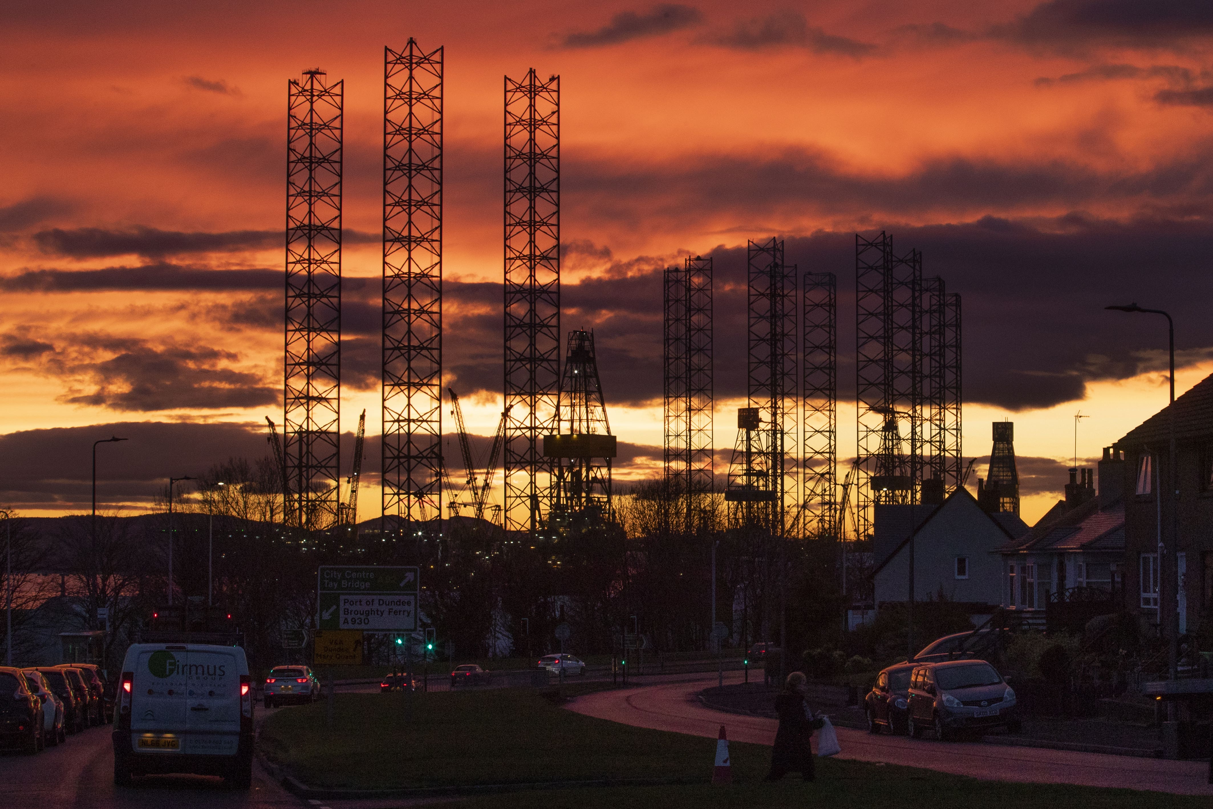 Jackup rigs, used in the North Sea oil and gas industry, are silhouetted against the sky at sunset over the Port of Dundee in the Firth of Tay, Dundee (Jane Barlow/PA)