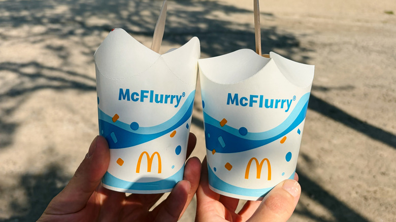 Two hands holding McFlurry cups