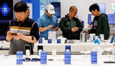 Customers try Samsung smartphones at one of the company's stores in Seoul