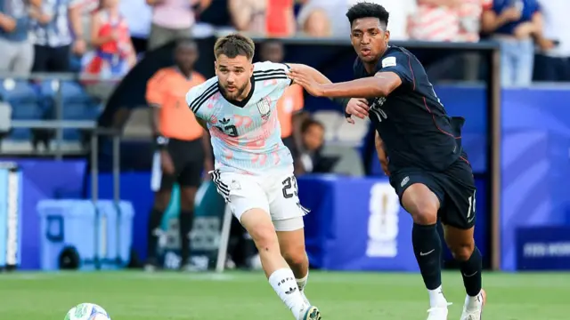 Alex Freeman of the United States and Nicolas Raskin of Belgium battle for the ball during the FIFA World Cup 2026 Round Of 16 match between USA and Belgium at Seattle Stadium on July 6, 2026 in Seattle, Washington.