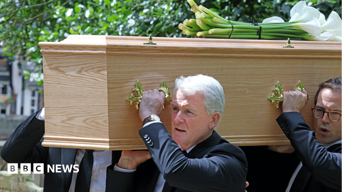 Mark Hughes is seen with others carrying his son's coffin into church