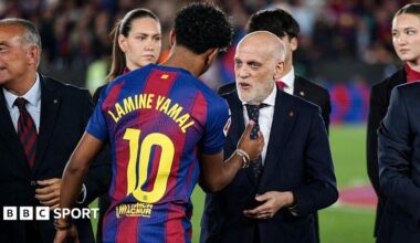 Lamine Yamal of Barcelona shakes hands with Javier Tebas, the president of La Liga