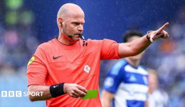 Rob Dieperink holds a yellow card