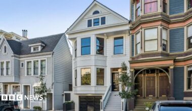 Three homes on a residential street in San Francisco. The three floor homes look clean and well maintained with well-trimmed plants and trees outside.