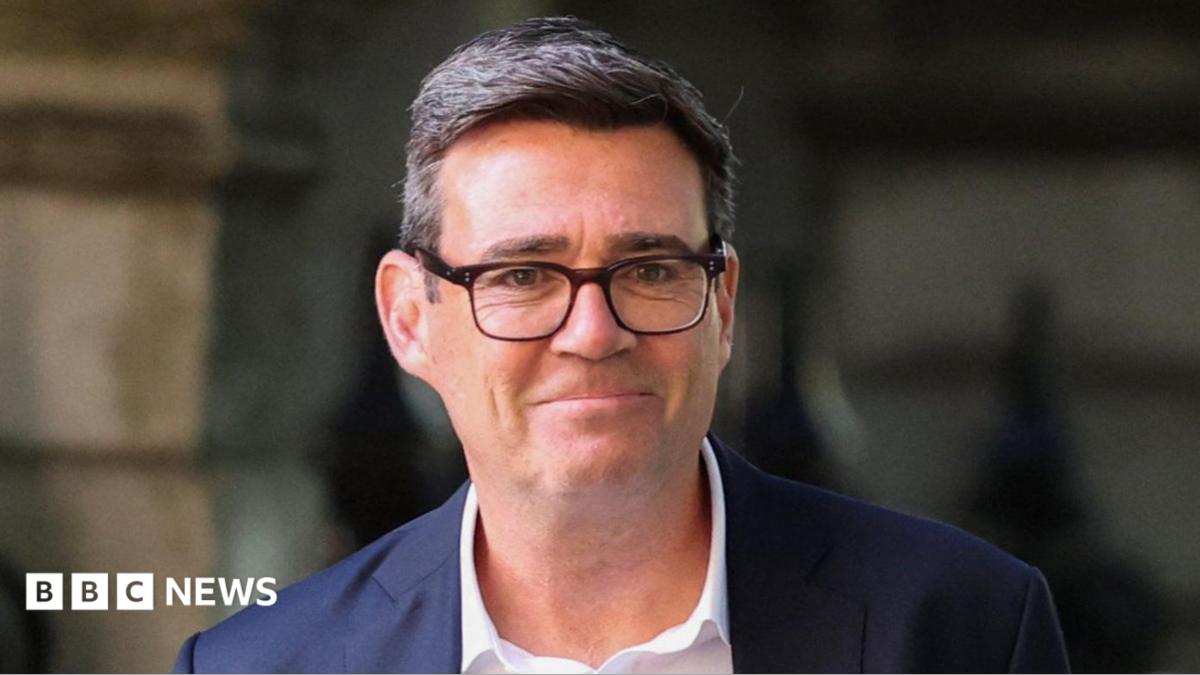 Andy Burnham pictured wearing a white shirt and dark suit