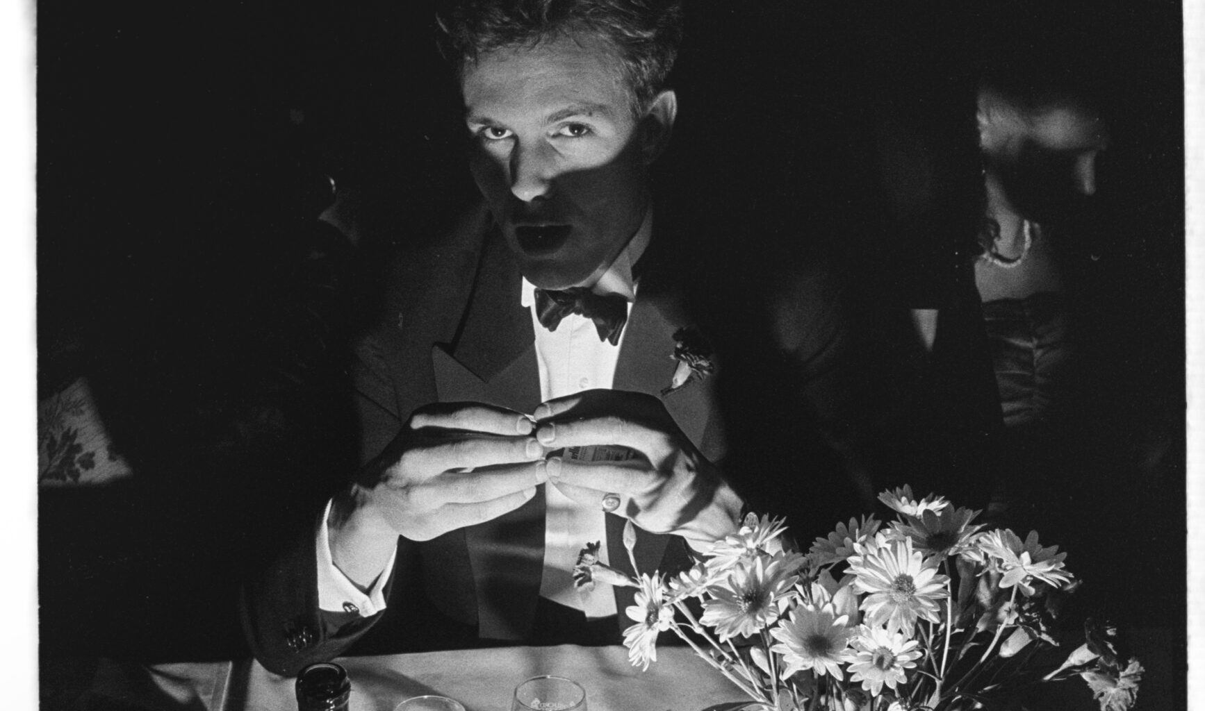Toby Mansell-Pleydell poses in candlelight with wine at Cambridge May Ball
