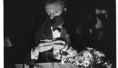 Toby Mansell-Pleydell poses in candlelight with wine at Cambridge May Ball
