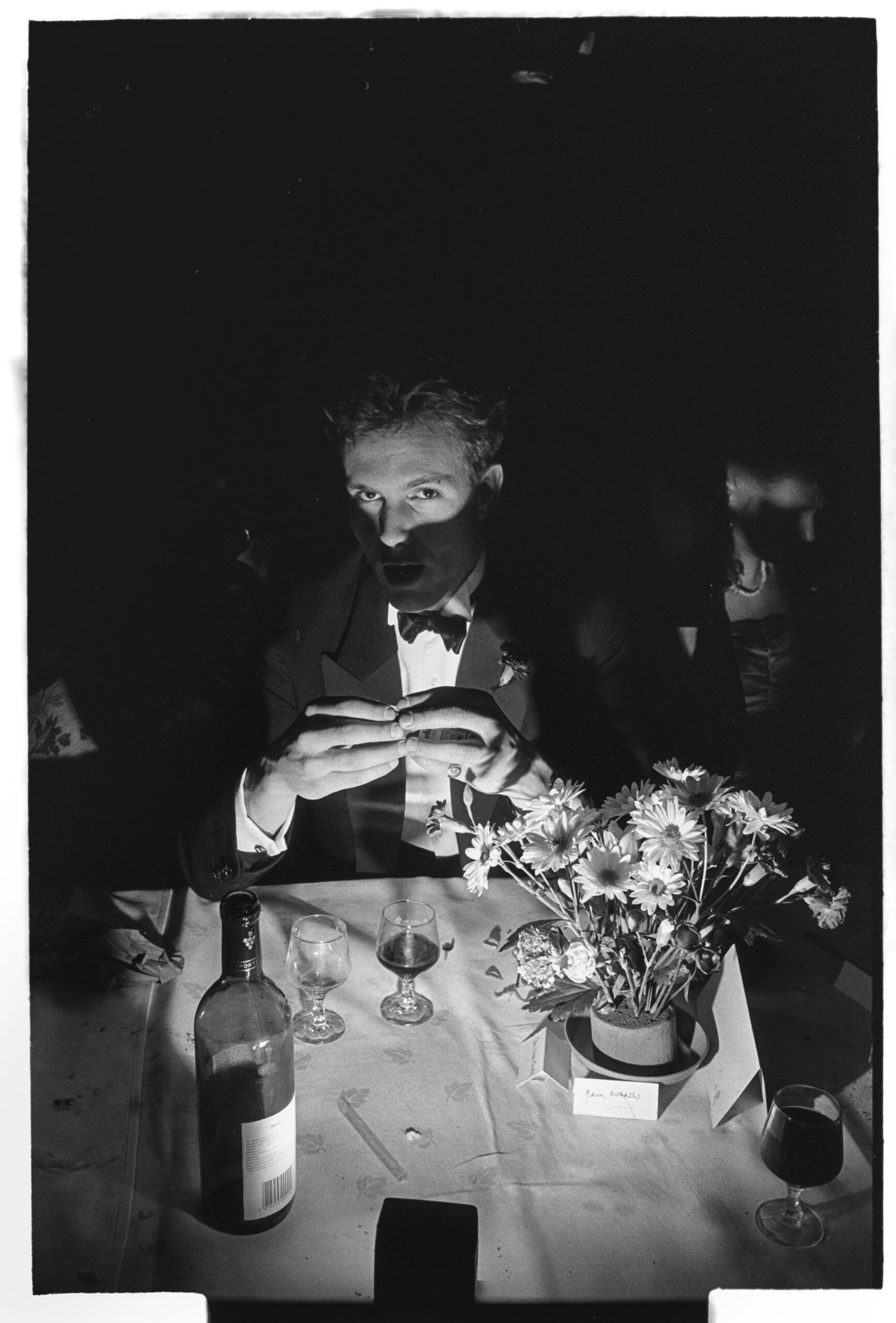 Toby Mansell-Pleydell poses in candlelight with wine at Cambridge May Ball