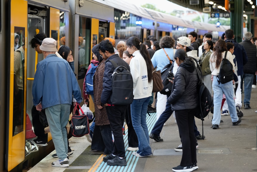 Commuters board a Sydney train