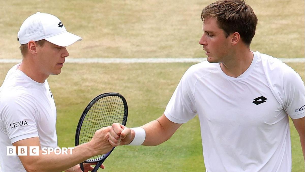 Henry Patten and Harri Heliovaara bump fists after winning a point at Wimbledon