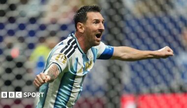 Lionel Messi celebrating with his arms out for Argentina
