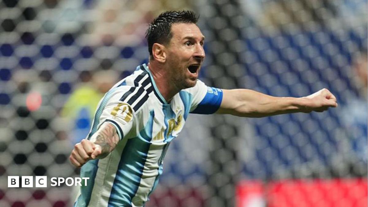 Lionel Messi celebrating with his arms out for Argentina