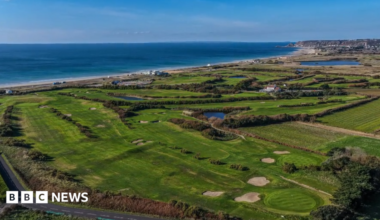 An aerial view of the golf course at Les Mielles. The sea is visible in the background.