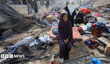 Palestinians inspect the site of Wednesday's Israeli strike on a house whose residents were pre-warned by the Israeli military to evacuate, in Gaza City