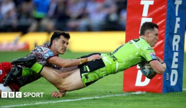 Wigan full-back Jai Field dives over the line to score against Leigh despite the attentions of Leopards wing David Armstrong