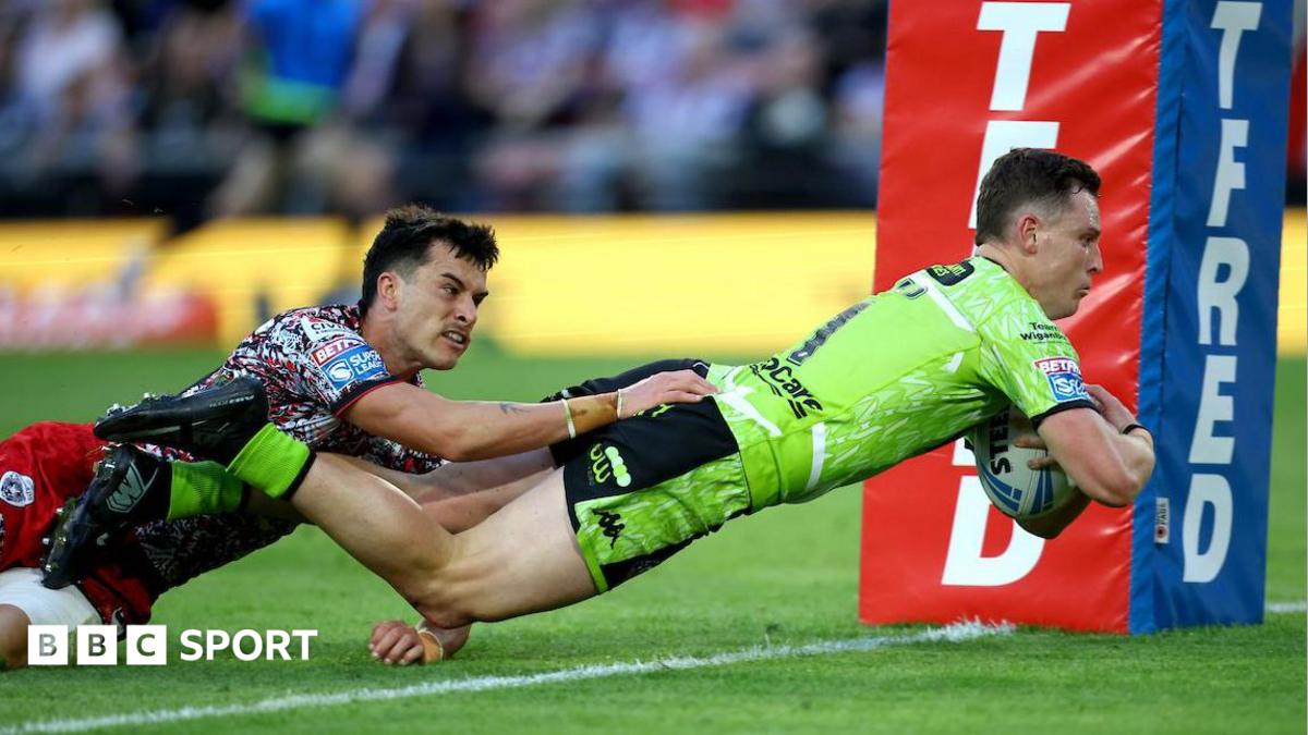 Wigan full-back Jai Field dives over the line to score against Leigh despite the attentions of Leopards wing David Armstrong