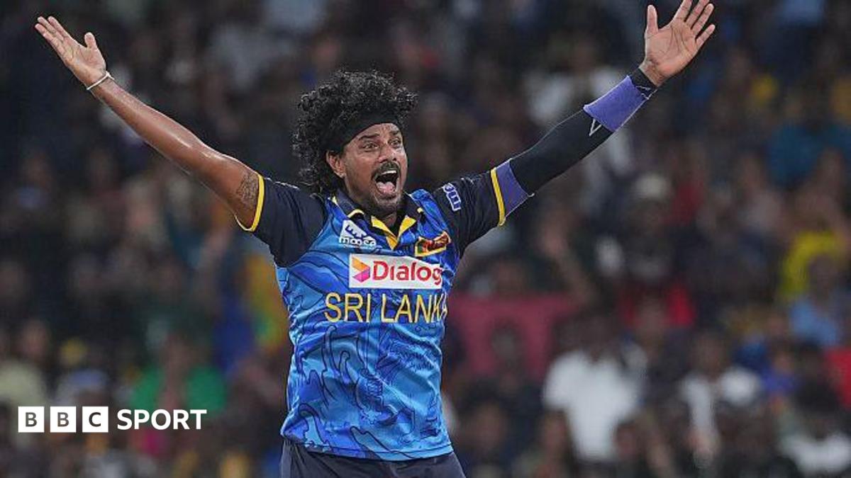 Binura Fernando with arms outstretched appealing for a wicket in a blue Sri Lanka shirt