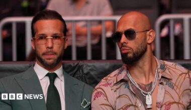 Andrew Tate and Tristan Tate are pictured sitting together at a UFC match.